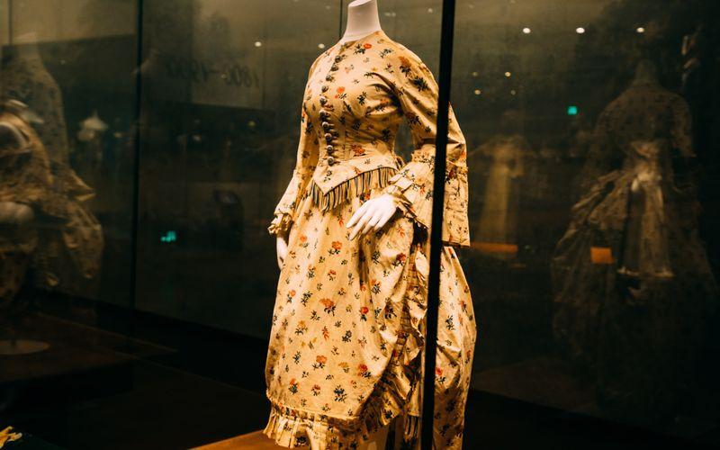 historical garment displayed inside a transparent glass museum showcase