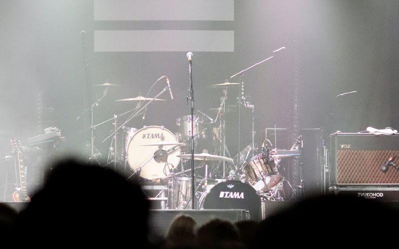 drum kit set up on a stage under performance lighting