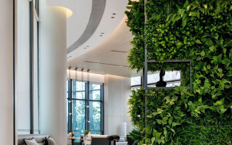 modern indoor lounge featuring a full height vertical garden feature wall